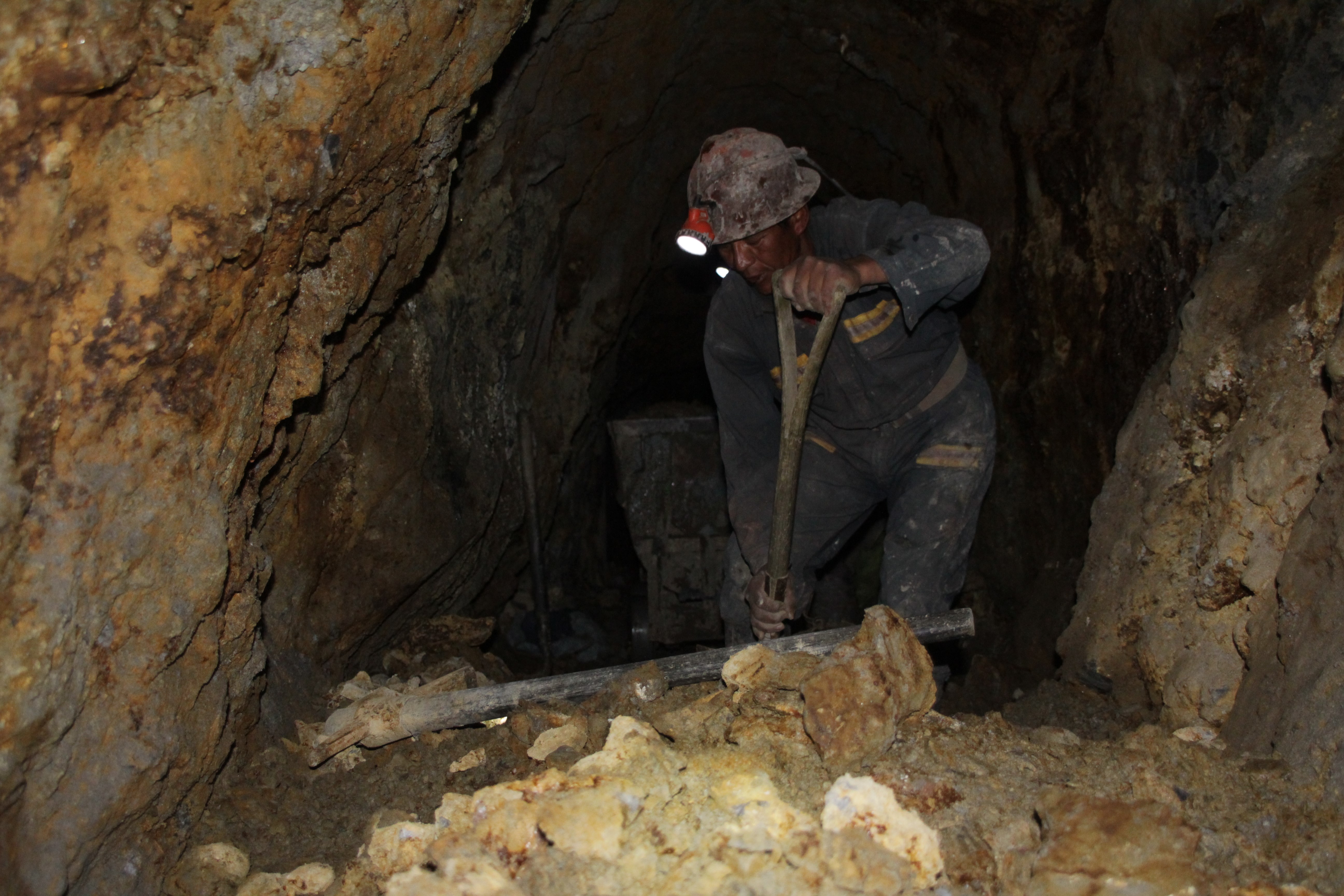 Un mineur creuse la roche manuellement pour tenter de trouver de l'argent (© Jérôme Decoster).